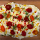 Butter Board seen from above with tomatoes and rosemary